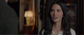 Movie still from “Office Christmas Party” (2016), directed by Will Speck – A woman with long black hair looking to her left; Close Up shot, Over the shoulder angle