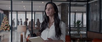 Movie still from “Office Christmas Party” (2016), directed by Will Speck – A woman in a white shirt is holding a tablet; Medium shot, Over the shoulder angle