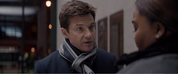 Movie still from “Office Christmas Party” (2016), directed by Will Speck – A person wearing a jacket and a scarf; Close Up shot, Over the shoulder angle