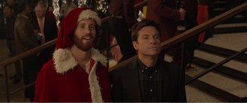 Movie still from “Office Christmas Party” (2016), directed by Will Speck – Two men standing next to each other in front of a staircase; Medium shot, Over the shoulder angle