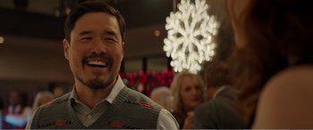 Movie still from “Office Christmas Party” (2016), directed by Will Speck – A person wearing a vest; Close Up shot, Over the shoulder angle