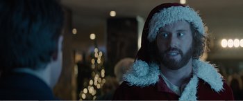 Movie still from “Office Christmas Party” (2016), directed by Will Speck – A man wearing a santa clause hat and a red coat; Close Up shot, Over the shoulder angle