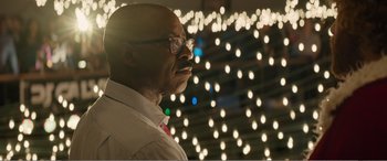 Movie still from “Office Christmas Party” (2016), directed by Will Speck – A man with glasses is standing in front of lights; Close Up shot, Low angle