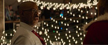 Movie still from “Office Christmas Party” (2016), directed by Will Speck – An older man wearing glasses and a red neck tie; Close Up shot, Low angle