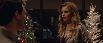 Movie still from “Office Christmas Party” (2016), directed by Will Speck – A beautiful young woman standing in front of a christmas tree; Close Up shot, Over the shoulder angle
