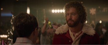 Movie still from “Office Christmas Party” (2016), directed by Will Speck – A man in a red jacket is looking at the camera; Close Up shot, Over the shoulder angle