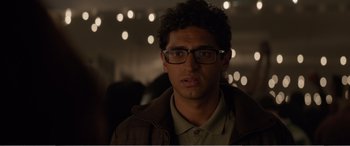 Movie still from “Office Christmas Party” (2016), directed by Will Speck – A young man wearing glasses and a brown jacket; Close Up shot, Over the shoulder angle