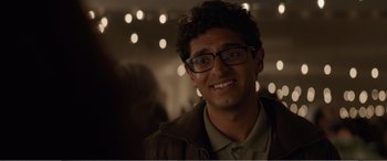 Movie still from “Office Christmas Party” (2016), directed by Will Speck – A person wearing glasses and a jacket; Close Up shot, Over the shoulder angle