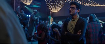Movie still from “Office Christmas Party” (2016), directed by Will Speck – A group of people standing in a room with lights; Medium shot, Over the shoulder angle