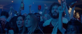 Movie still from “Office Christmas Party” (2016), directed by Will Speck – A group of people sitting in front of a crowd; Medium shot, Low angle