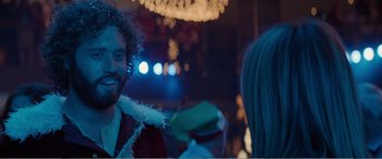 Movie still from “Office Christmas Party” (2016), directed by Will Speck – A man with a beard is talking to a woman in front of lights; Close Up shot, Over the shoulder angle