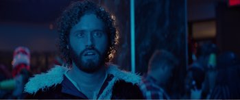 Movie still from “Office Christmas Party” (2016), directed by Will Speck – A man with curly hair and a beard is looking at the camera; Close Up shot, Over the shoulder angle