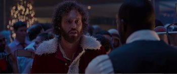 Movie still from “Office Christmas Party” (2016), directed by Will Speck – A man with a beard is talking to another man in a crowd; Close Up shot, Over the shoulder angle