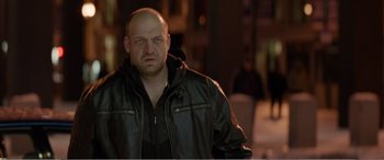 Movie still from “Office Christmas Party” (2016), directed by Will Speck – A bald man in a leather jacket looking at the camera; Close Up shot, Low angle