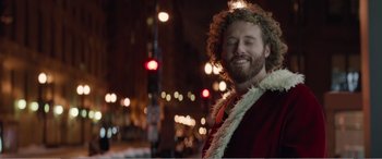 Movie still from “Office Christmas Party” (2016), directed by Will Speck – A man in a red shirt and a white lei; Close Up shot, Low angle