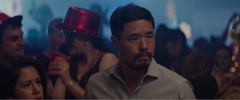 Movie still from “Office Christmas Party” (2016), directed by Will Speck – A person wearing a hat; Close Up shot, Over the shoulder angle