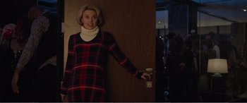 Movie still from “Office Christmas Party” (2016), directed by Will Speck – A woman standing in front of a wooden door; Medium shot, Over the shoulder angle