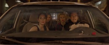 Movie still from “Office Christmas Party” (2016), directed by Will Speck – A group of people sitting in a car looking out of the window; Medium shot, High angle