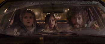 Movie still from “Office Christmas Party” (2016), directed by Will Speck – A group of people sitting in the back of a car; Medium shot, Low angle