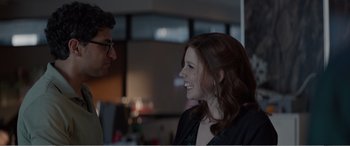 Movie still from “Office Christmas Party” (2016), directed by Will Speck – A woman smiling at a man in a black shirt; Close Up shot, Over the shoulder angle