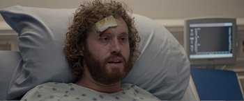Movie still from “Office Christmas Party” (2016), directed by Will Speck – A man with a bandage on his head; Close Up shot, Over the shoulder angle