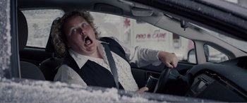 Movie still from “Office Christmas Party” (2016), directed by Will Speck – A woman driving a car in the middle of the road; Close Up shot, Over the shoulder angle