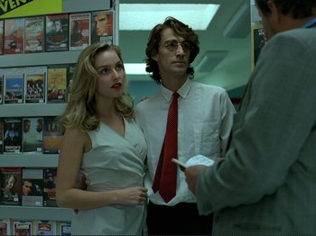 Movie still from “Oh, Woe Is Me” (1993), directed by Jean-Luc Godard – A man and a woman standing next to each other; Medium shot, Low angle