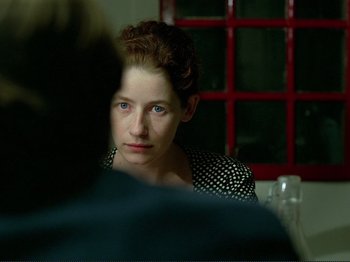 Movie still from “Oh, Woe Is Me” (1993), directed by Jean-Luc Godard – A woman sitting in front of another woman; Close Up shot, Over the shoulder angle