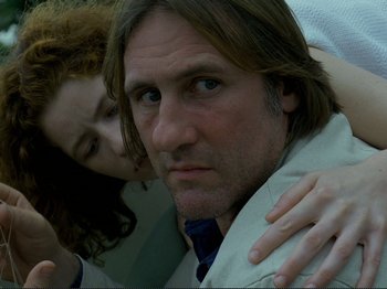 Movie still from “Oh, Woe Is Me” (1993), directed by Jean-Luc Godard – A man and a woman are posing for a picture; Close Up shot, Low angle