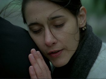Movie still from “Oh, Woe Is Me” (1993), directed by Jean-Luc Godard – A person with her eyes closed; Close Up shot, Low angle