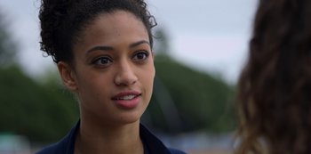 Movie still from “13 Reasons Why” (2017), created by Brian Yorkey – A woman's face in front of trees; Close Up shot, Over the shoulder angle