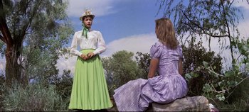 Movie still from “Oklahoma!” (1955), directed by Fred Zinnemann – Two women dressed up as mary poppins; Medium shot, Low angle