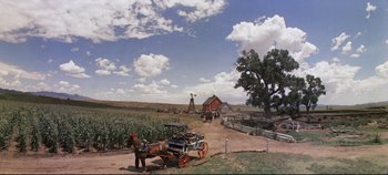 Movie still from “Oklahoma!” (1955), directed by Fred Zinnemann – A horse drawn carriage in the middle of a field; Extreme Wide shot, High angle