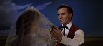 Movie still from “Oklahoma!” (1955), directed by Fred Zinnemann – A wax statue of a man holding a wedding veil; Close Up shot, Low angle