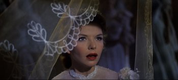 Movie still from “Oklahoma!” (1955), directed by Fred Zinnemann – A person wearing a veil; Close Up shot, Low angle