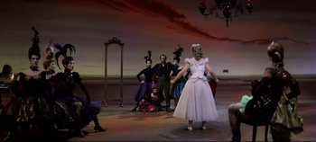 Movie still from “Oklahoma!” (1955), directed by Fred Zinnemann – A group of people standing on a stage; Wide shot, High angle