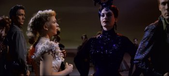 Movie still from “Oklahoma!” (1955), directed by Fred Zinnemann – Two women dressed up in costumes talking to each other; Medium shot, Low angle