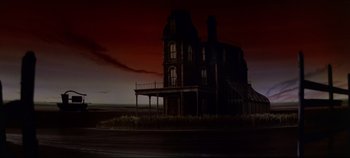 Movie still from “Oklahoma!” (1955), directed by Fred Zinnemann – An old abandoned house with a dark sky in the background at night; Extreme Wide shot, Low angle