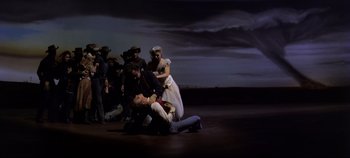 Movie still from “Oklahoma!” (1955), directed by Fred Zinnemann – A group of people standing on top of each other in the dark; Wide shot, Low angle