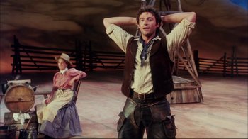 Movie still from “Oklahoma!” (1999), directed by Trevor Nunn – A man and a woman in cowboy outfits; Medium shot, Low angle