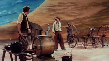 Movie still from “Oklahoma!” (1999), directed by Trevor Nunn – An oil painting of a scene in a western setting; Wide shot, Low angle