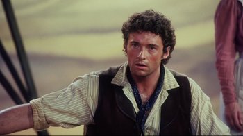 Movie still from “Oklahoma!” (1999), directed by Trevor Nunn – A person wearing a shirt and a vest; Close Up shot, Over the shoulder angle