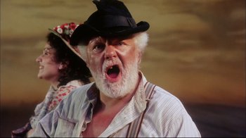 Movie still from “Oklahoma!” (1999), directed by Trevor Nunn – An old man with a beard wearing a black hat; Close Up shot, Low angle