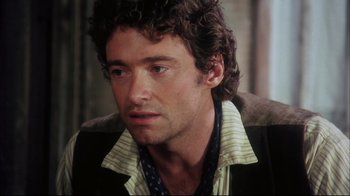 Movie still from “Oklahoma!” (1999), directed by Trevor Nunn – A person with curly hair; Close Up shot, Over the shoulder angle