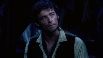 Movie still from “Oklahoma!” (1999), directed by Trevor Nunn – A person wearing a shirt and vest; Close Up shot, Over the shoulder angle