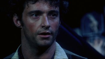Movie still from “Oklahoma!” (1999), directed by Trevor Nunn – A man's face in a dark room; Close Up shot, Low angle