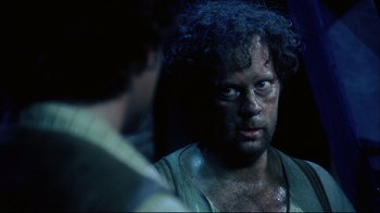 Movie still from “Oklahoma!” (1999), directed by Trevor Nunn – A person with a face covered in mud; Close Up shot, Over the shoulder angle
