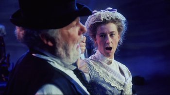 Movie still from “Oklahoma!” (1999), directed by Trevor Nunn – A man and a woman in old - fashioned clothing; Medium shot, Over the shoulder angle