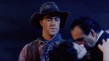 Movie still from “Oklahoma!” (1999), directed by Trevor Nunn – A man wearing a cowboy hat and a neck tie; Close Up shot, Low angle