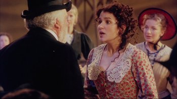 Movie still from “Oklahoma!” (1999), directed by Trevor Nunn – An older man and a young woman talking to each other; Medium shot, Over the shoulder angle